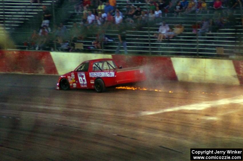 Bill Collins’ Chevy is done for the race and crawls out of turn 4.