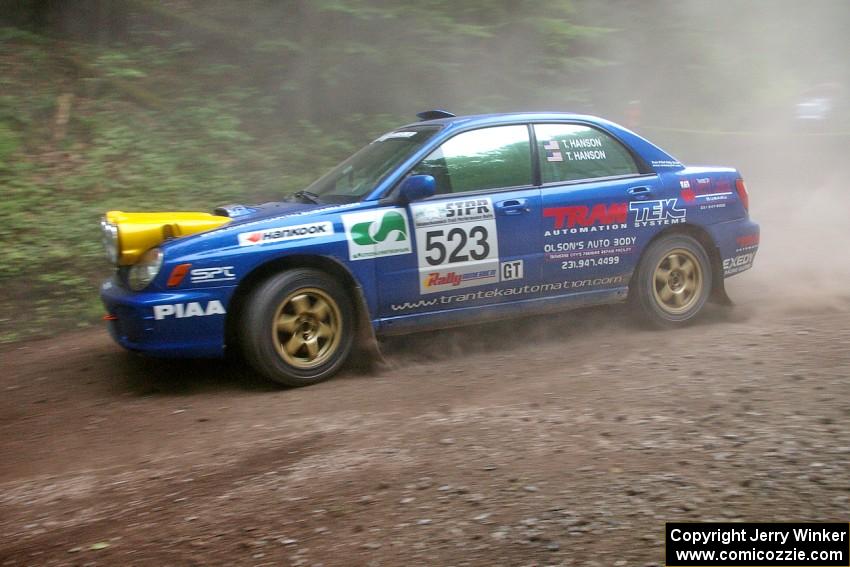 Travis Hanson / Terry Hanson go wide at the exit of a hairpin on SS6 in their Subaru WRX.