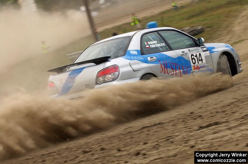 Piotr Wiktorczyk / Martin Brady	fly past on SS1 in their Subaru WRX.