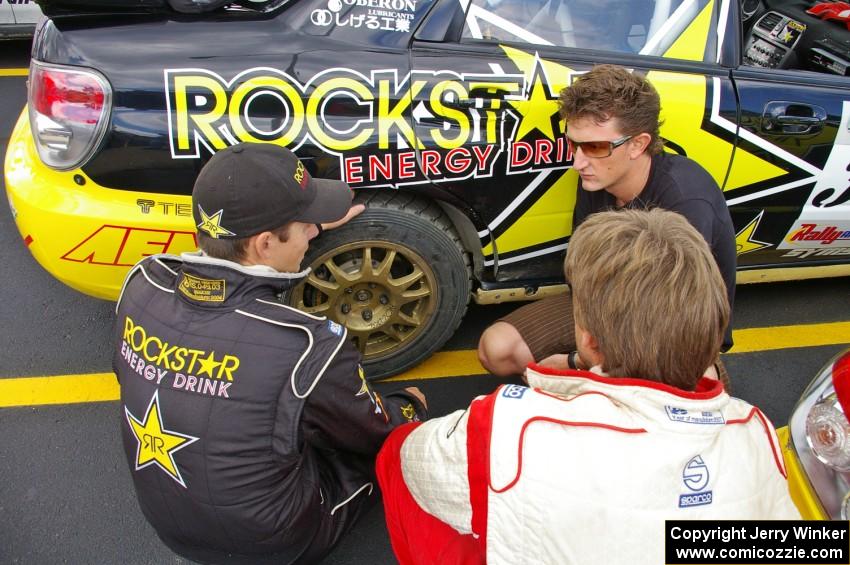 Tanner Foust (back to the camera), Andy Pinker, and Stephan Verdier talk strategy prior to day two of the rally (2).