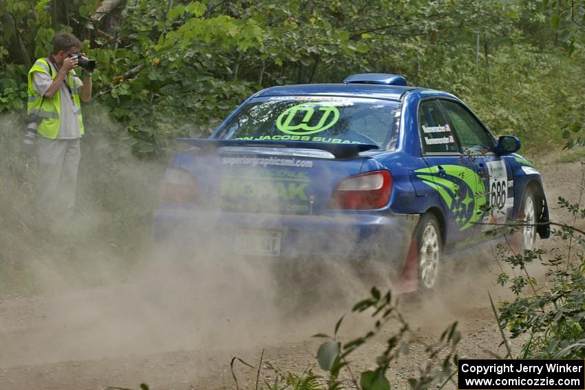 Pete Kuncis snaps a shot of the Heath Nunnemacher / Heidi Nunnemacher Subaru WRX as they exit out of a 90-left on SS9.