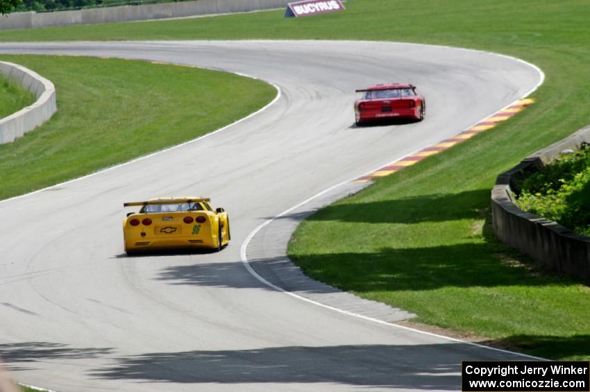 David Fershtand's Olds Cutlass Supreme ahead of Daniel Parr's Chevy Corvette through corner 13.