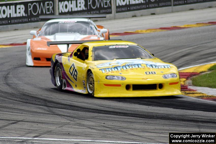 John Schaller's Chevy Camaro ahead of Simon Gregg's Chevy Corvette