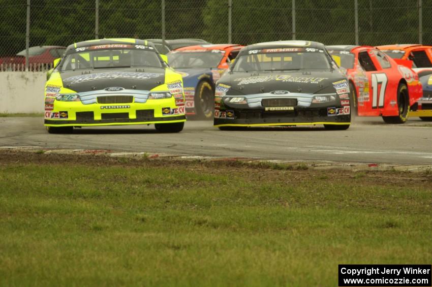 26) Greg Pursley's Ford Fusion and 03) Dylan Kwasniewski's Ford Fusion at the first turn