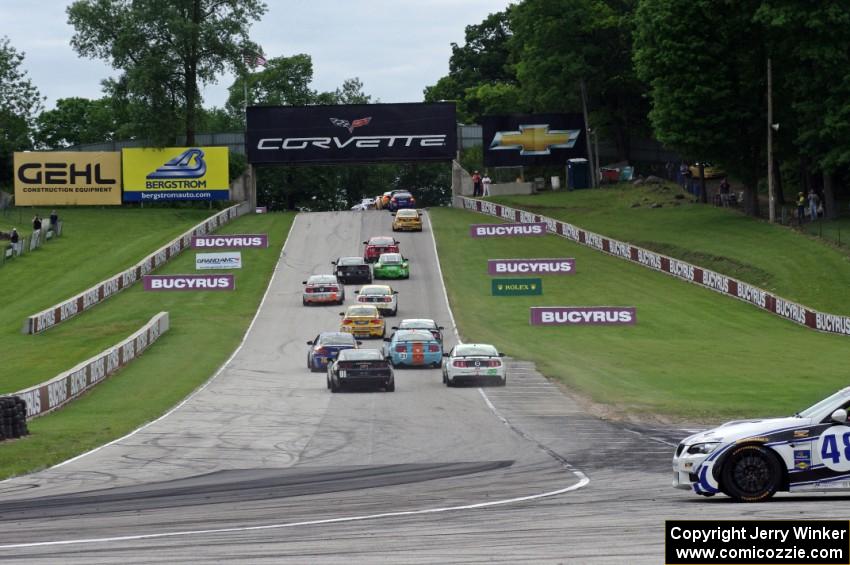 Charles Espenlaub / Charlie Putman BMW M3 Coupe waits as the GS field heads uphill from turn 5 on the first lap.