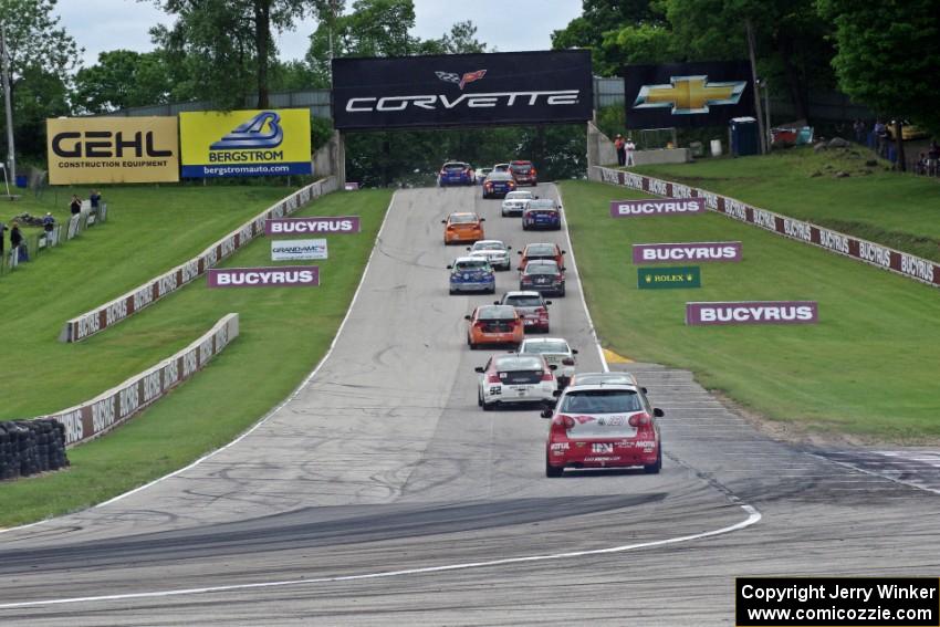 The ST field heads uphill from turn 5 on the first lap.