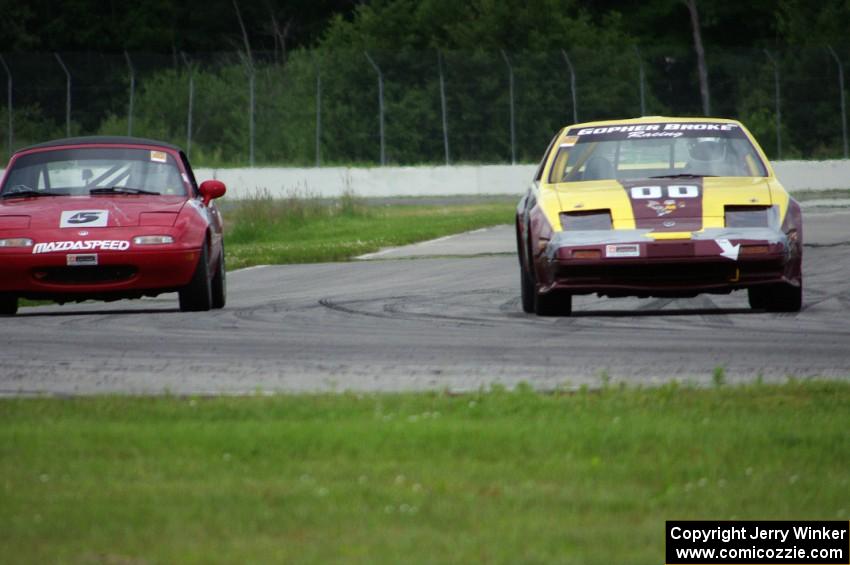 Gopher Broke Racing Nissan 300ZX passes the Penalty Lap Racing Mazda Miata