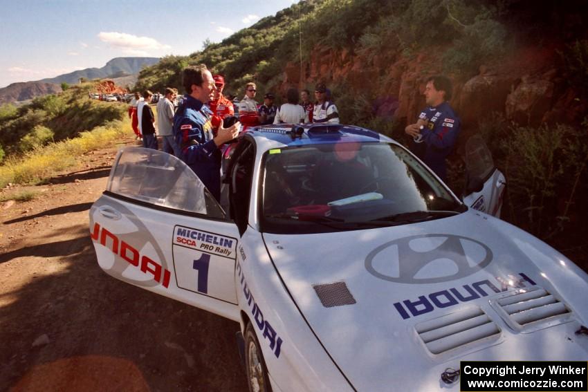 Paul Choinere / Jeff Becker plan strategy before the start of SS1 in their Hyundai Tiburon.