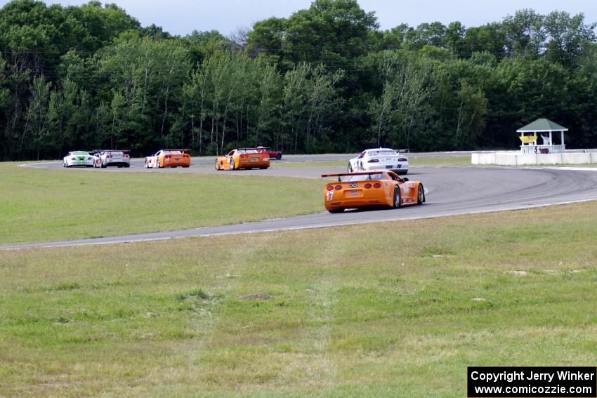 Tony Ave leads Tomy Drissi, R.J. Lopez, Simon Gregg, Jim Derhaag, Buddy Cisar and Bobby Sak on the pace lap into turn 5.