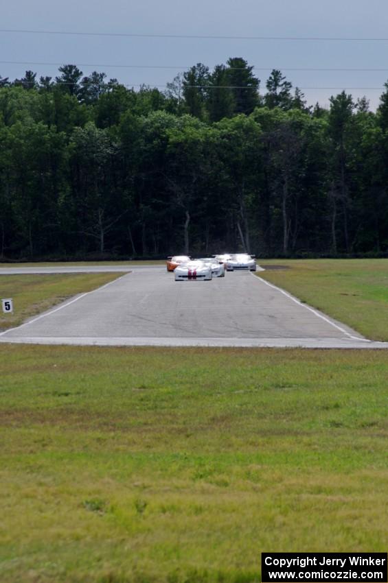 Tony Ave leads Tomy Drissi, R.J. Lopez, Bobby Sak, Jim Derhaag, Simon Gregg and Buddy Cisar on the first lap into turn 4.