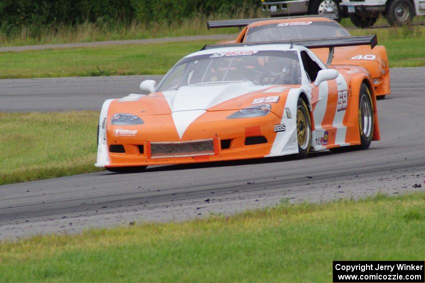 Simon Gregg's Chevy Corvette leads Jim Derhaag's Chevy Corvette