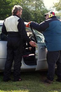 David Jans' chats with a corner worker before catching a ride back to the pits after his wreck.