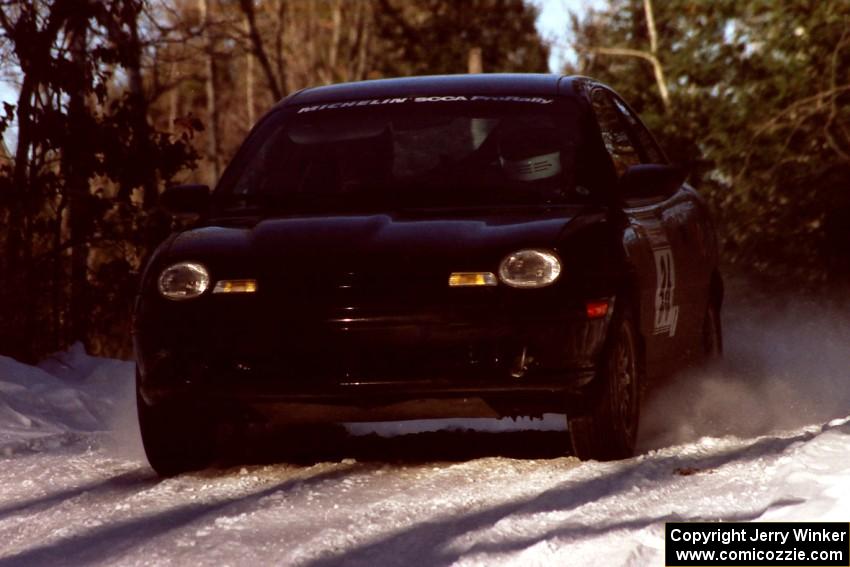 Evan Moen / Ron Moen Plymouth Neon ACR at speed over a blind crest before sunset.