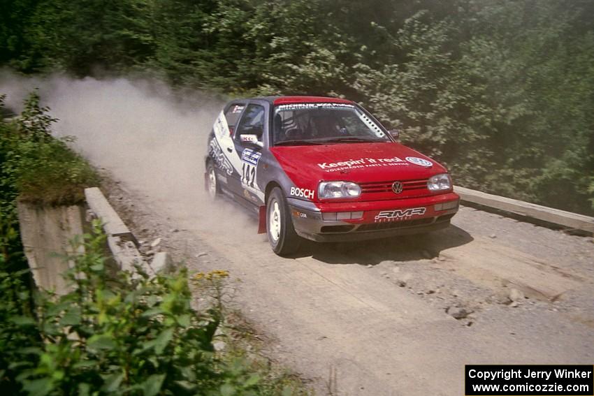 Jon Nichols / Mike Koch VW Golf at speed over a bridge on SS5, Magalloway North.