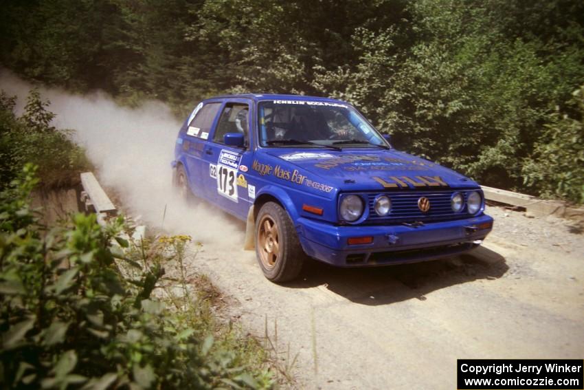 Patrick Lilly / Mark McAllister VW GTI at speed over a bridge on SS5, Magalloway North.