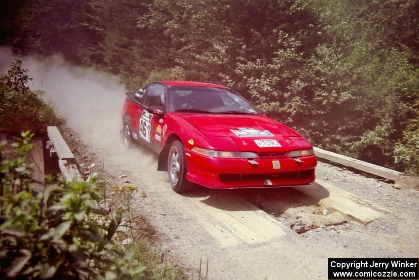 Brendan Cunningham / Paul McClean Eagle Talon at speed over a bridge on SS5, Magalloway North.