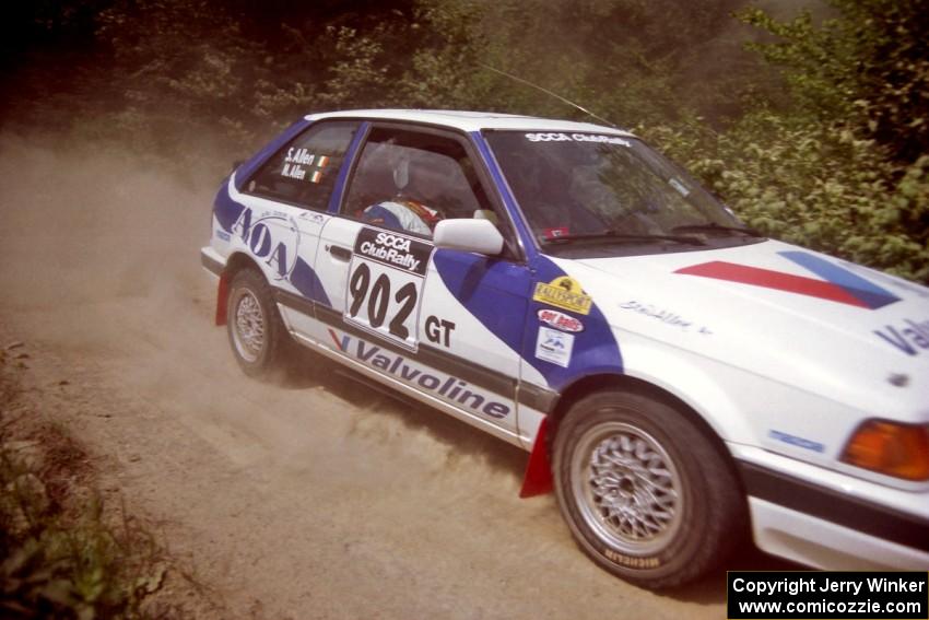 Marty Allen / Stewart Allen Mazda 323GTX at speed over a bridge on SS5, Magalloway North.