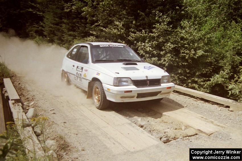 Matt Lewis / Tony Lumino Pontiac LeMans at speed over a bridge on SS5, Magalloway North.