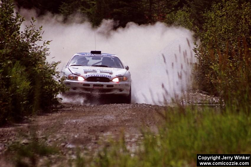 Noel Lawler / Charles Bradley Hyundai Tiburon splashes through a puddle on SS8, Parmachenee Long.