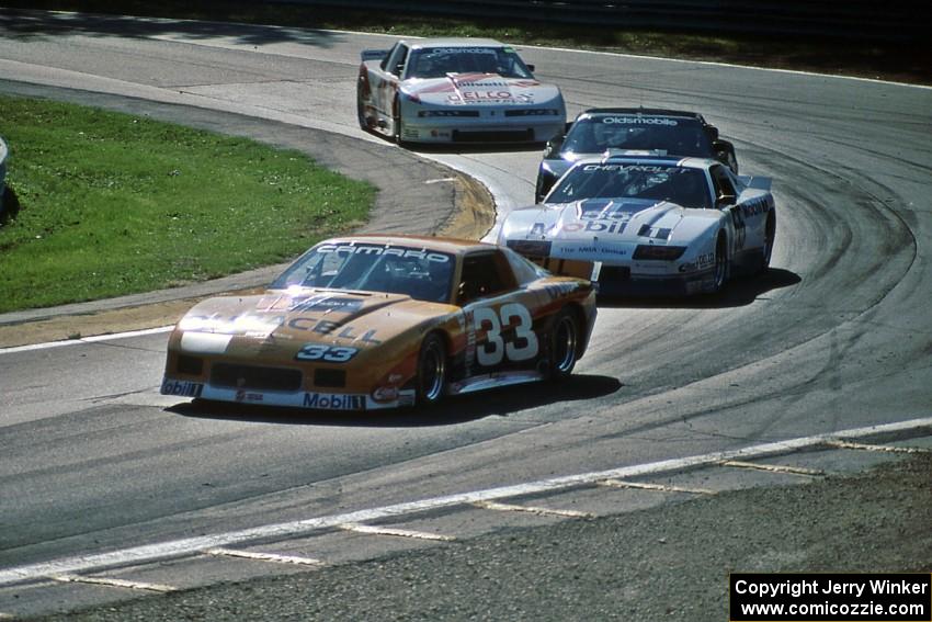 Scott Sharp's Chevy Camaro leads Bob Sobey's Chevy Camaro and Darin Brassfield's and Chris Kneifel's Olds Cutlass Supremes