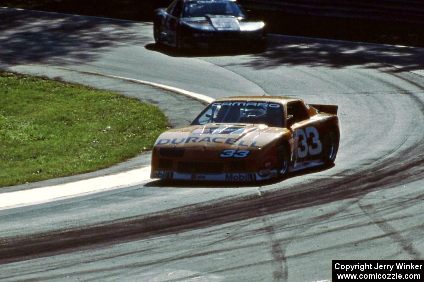 Scott Sharp's Chevy Camaro leads Darin Brassfield's Olds Cutlass Supreme