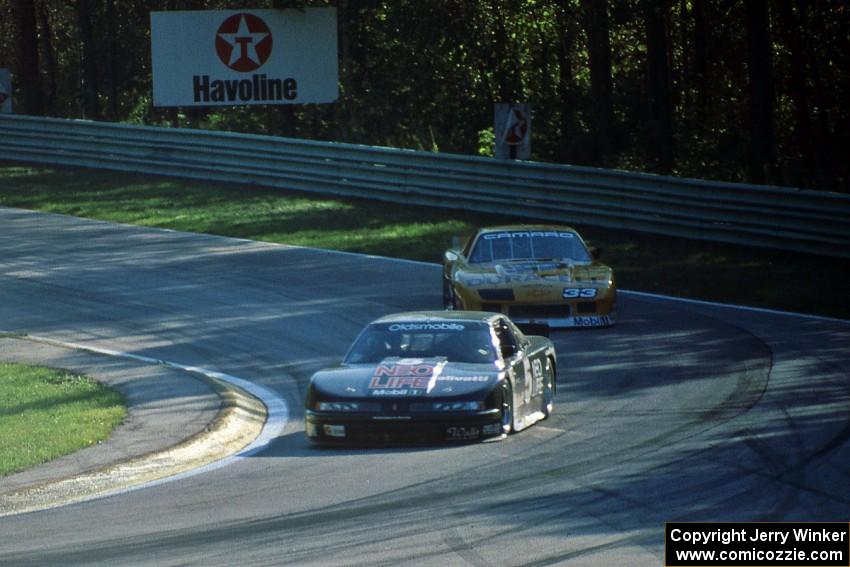 Darin Brassfield's Olds Cutlass Supreme leads Scott Sharp's Chevy Camaro