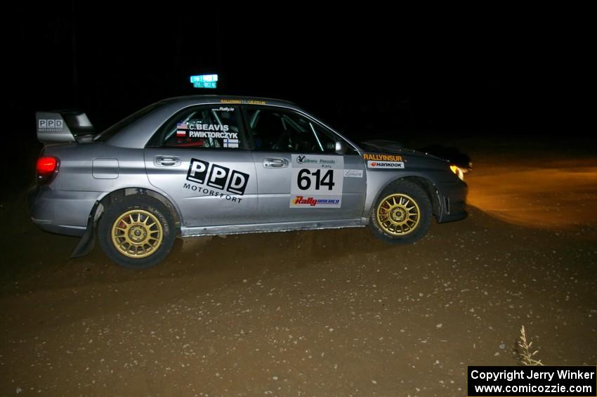 Piotr Wiktorczyk / Chrissie Beavis exit a right-hand hairpin on SS8 in their Subaru WRX STi.