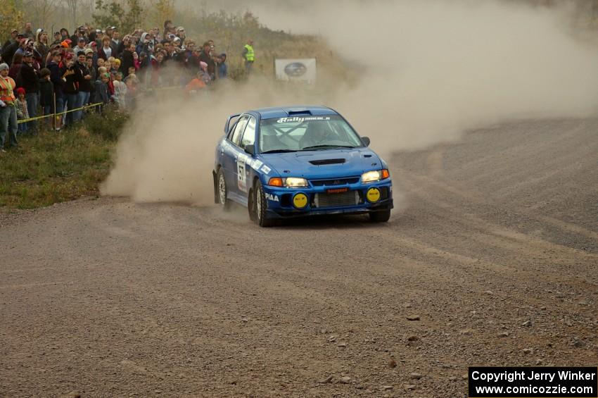 Dmitri Kishkarev / Kim DeMotte come into the spectator point of SS1, Green Acres, in their Mitsubishi Lancer Evo IV.