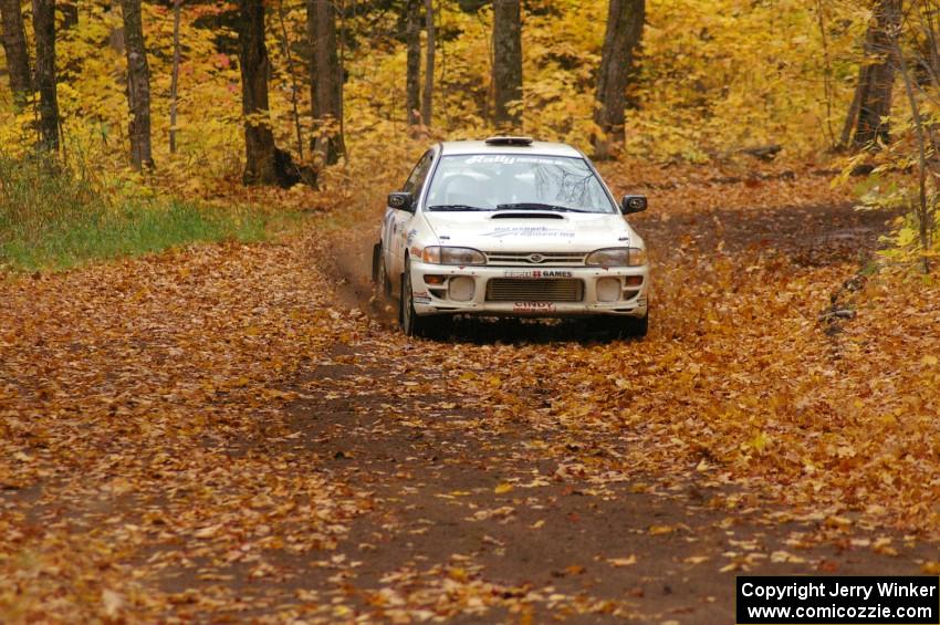 Henry Krolikowski / Cindy Krolikowski drift through a leaf covered corner on SS2, Beacon Hill, in their Subaru Impreza.