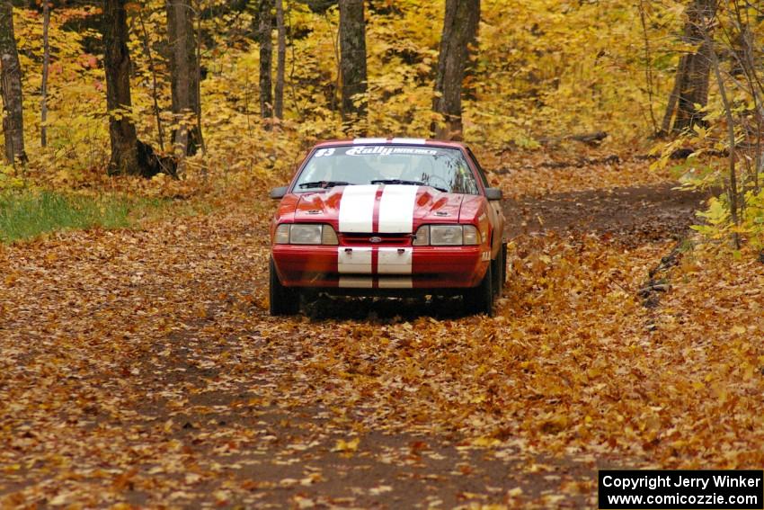 Mark Utecht / Rob Bohn take it easy on a slippery corner on SS2, Beacon Hill, in their Ford Mustang.