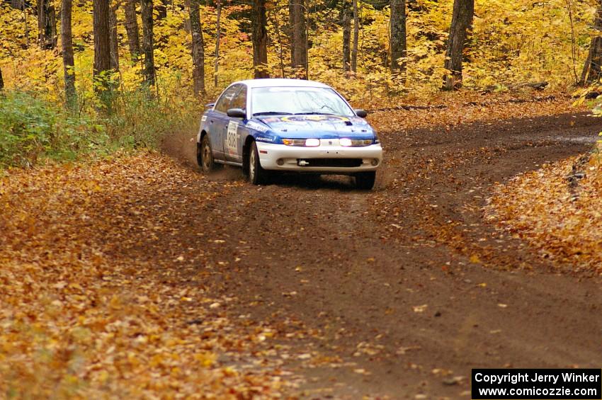 Mike Isaacs / Craig Walli drift their Saturn SL2 through a sweeper near the end of SS2, Beacon Hill.