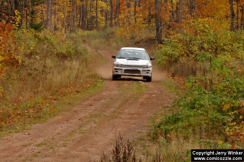 Henry Krolikowski / Cindy Krolikowski blast down a straight on Gratiot Lake 1, SS10, in their Subaru Impreza.