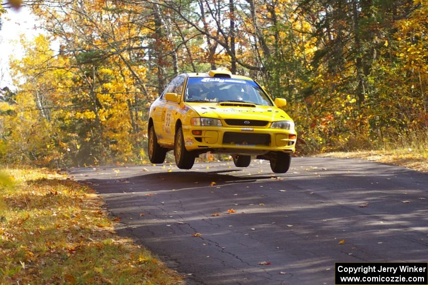 Kyle Sarasin / Mikael Johansson catch air at the midpoint jump of Brockway 1, SS13, in their Subaru Impreza.