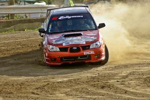 The Piotr Wiktorczyk / Grzegorz Dorman Subaru WRX STi drifts hard through a hairpin on SS1.