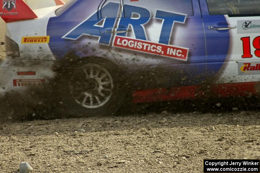 Arkadiusz Gruszka / Lukasz Wronski get back on the gas of their Mitsubishi Lancer Evo 9 at the speedway stage, SS1.