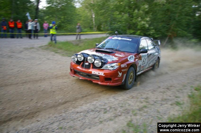 The Piotr Wiktorczyk / Grzegorz Dorman Subaru WRX STi rockets through a sweeper on SS2.