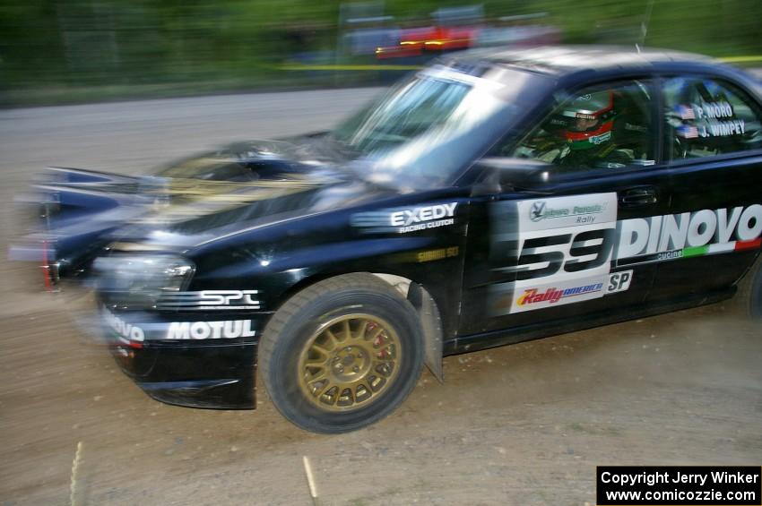 Pat Moro / Jeremy Wimpey at speed in their Subaru WRX STi through a fast sweeper on SS2.