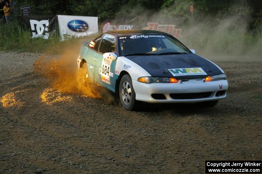 Adam Markut / Chris Gordon drift their Eagle Talon through the spectator-filled uphill hairpin on SS4.