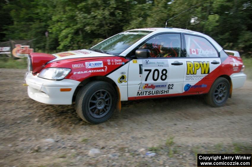 Jan Zedril / Jody Zedril take the uphill hairpin on SS4 in their Mitsubishi Lancer ES.