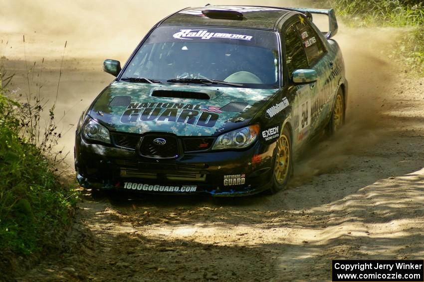 Mark Fox / Jake Blattner power out of an uphill 90-right on SS11 in their Subaru WRX STi.