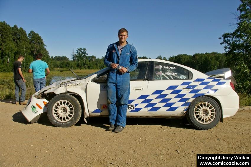 Zach Babcock stands in front of the Dodge SRT-4 he and Jack Penley rolled hard on SS11.(2)