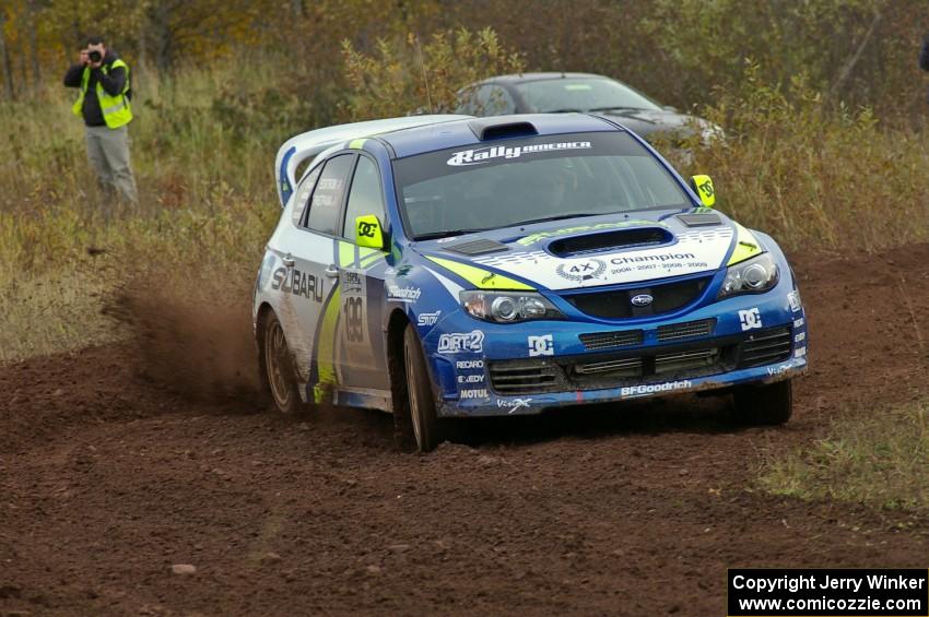 Travis Pastrana / Christian Edstrom spray gravel at a tight corner on the practice stage in their Subaru WRX STi.