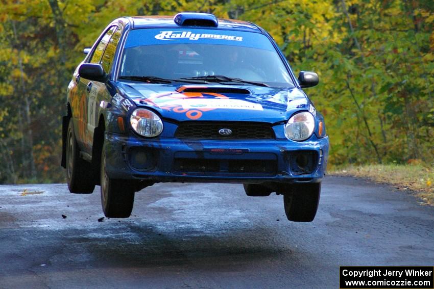 Tim Penasack / Alex Kihurani catch nice air at the midpoint jump on Brockway Mtn. 1, SS13, in their Subaru WRX.