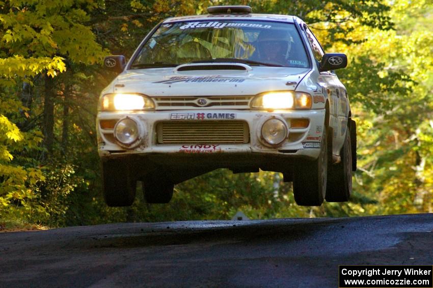 Henry Krolikowski / Cindy Krolikowski catch nice air in their Subaru Impreza on the midpoint jump on Brockway Mtn. 2, SS16.