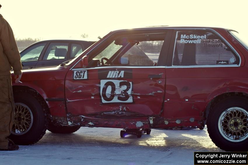 The Pete Tavenier / Bruce Powell BMW 318i sports heavy damage to the driver's door.