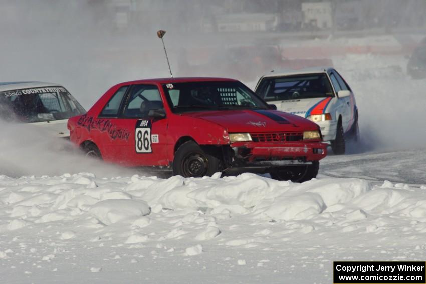 The Chad Reinhofer / Jason Lindell / Cody Reinhofer Plymouth Sundance, and Andy Orr / Jerry Orr Mazda 323GTX in turn one.