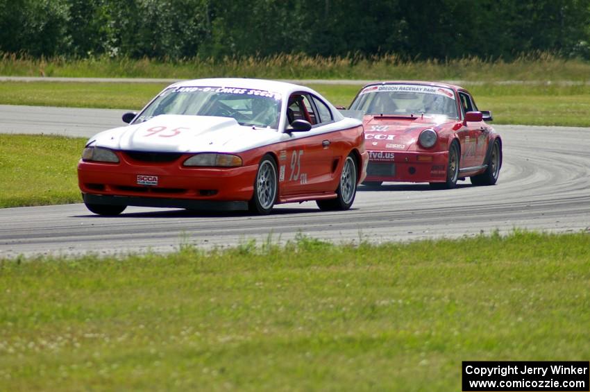 Tom Fuehrer's STO Ford Mustang battles the ITR Porsche 911 of Shannon Ivey