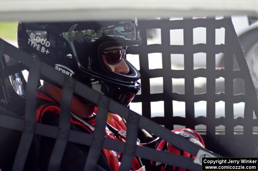 Shannon Ivey sits in his Chevy Camaro