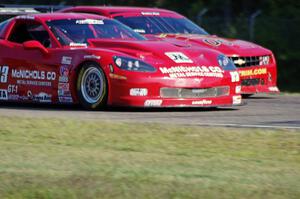 Amy Ruman's Chevy Corvette passes Bob Stretch's Chevy Camaro into turn three.