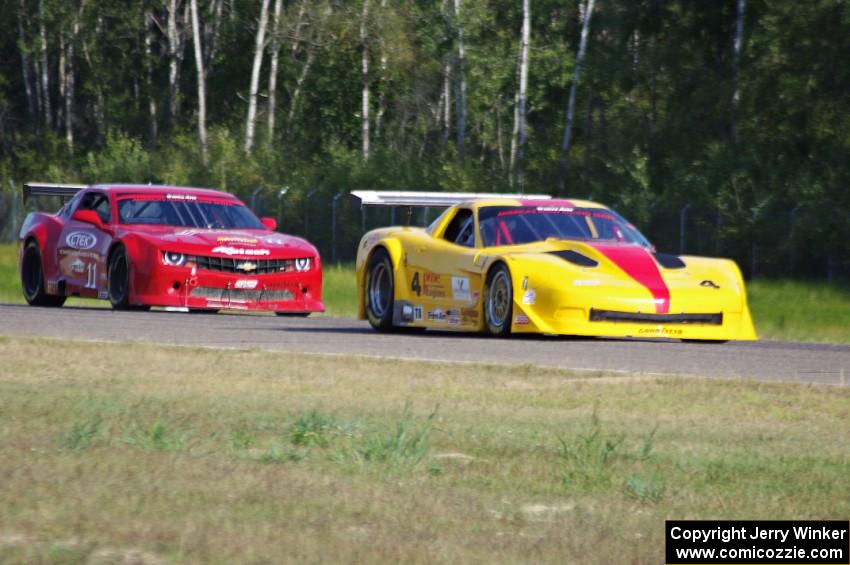 Tony Ave's Chevy Corvette passes Cameron Lawrence's Chevy Camaro into turn three.